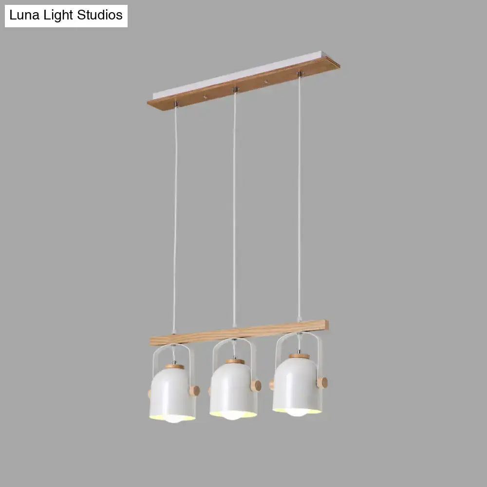 Modern white pendant light with three grey dome shades hanging from a wooden frame by decorbites