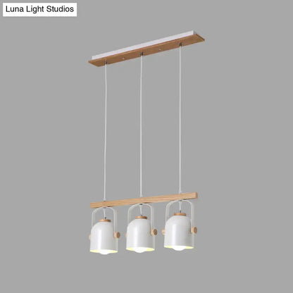 Modern white pendant light with three grey dome shades hanging from a wooden frame by decorbites