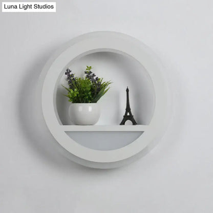Modern white halo ring wall light fixture with recessed center and lower shelf for minimalist bedroom wall light design