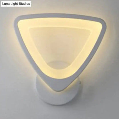 Modern white heart led wall sconce with minimalist triangular design and soft warm glow for bedroom lighting