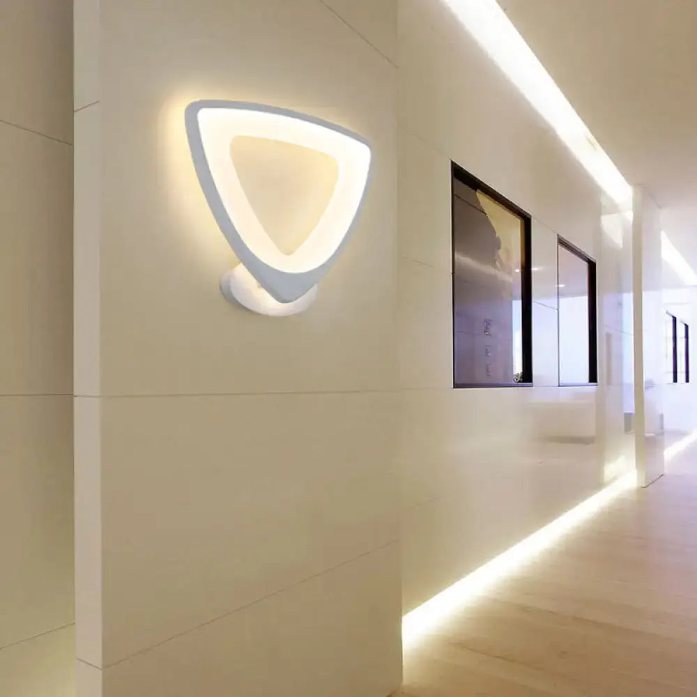 Modern white triangular led wall sconce with a sleek minimalist design for bedroom lighting
