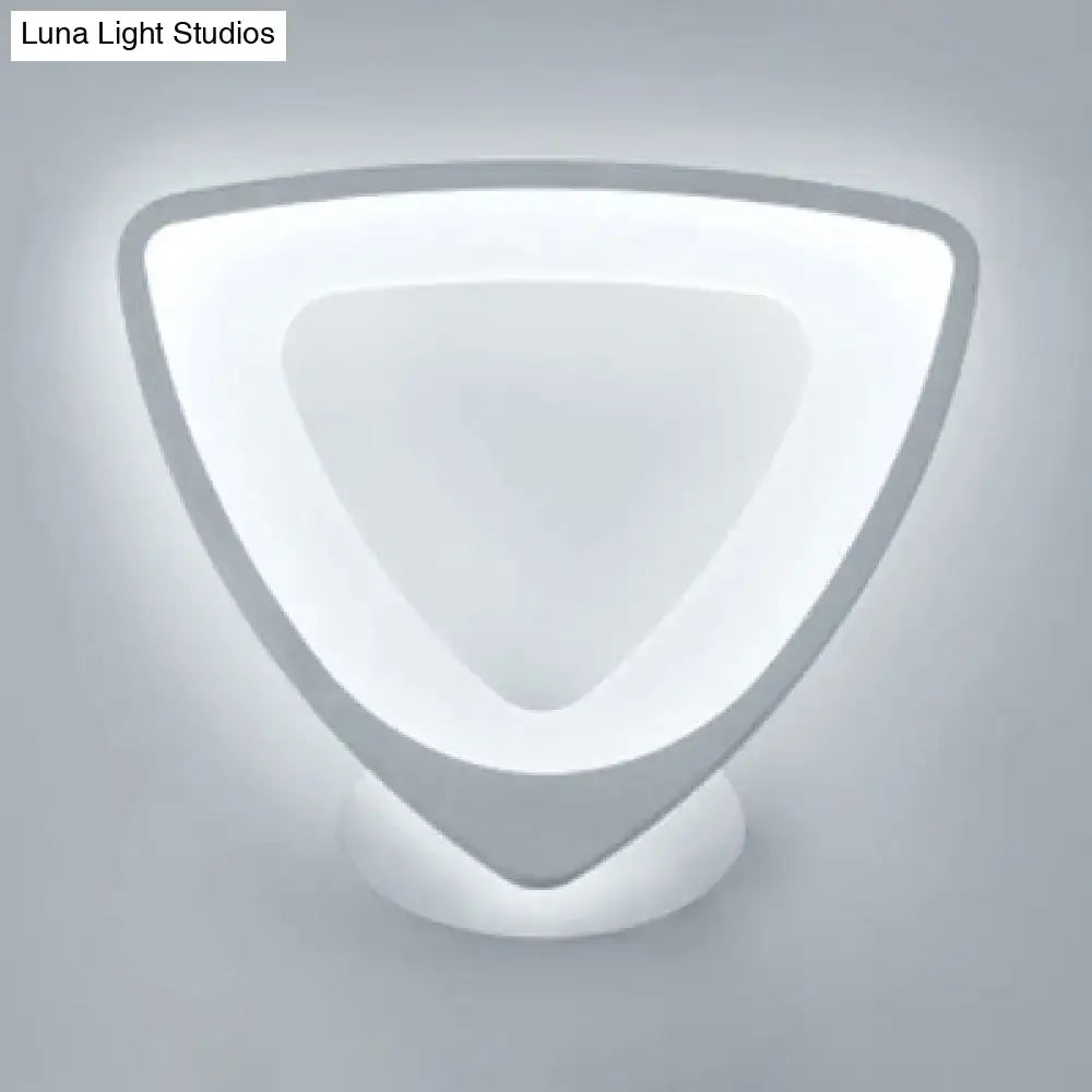 Modern white heart led wall sconce with sleek white acrylic and matte gray metal frame emitting soft ambient light