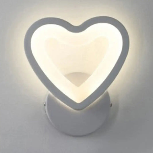 Modern white heart led wall sconce with a sleek minimalist design for bedroom lighting mounted on the wall