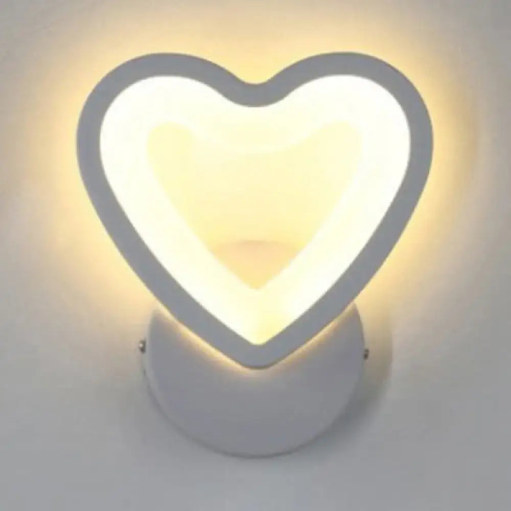 Modern white heart led wall sconce with a soft warm-glowing light, sleek gray frame, and smooth white base for bedroom use