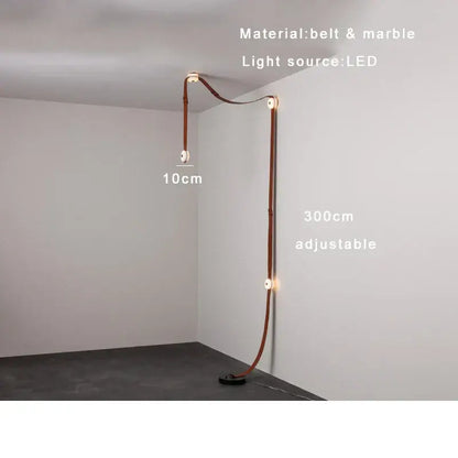 A sleek adjustable floor lamp featuring a brown leather decorbites designer belt and designer belt marble accents