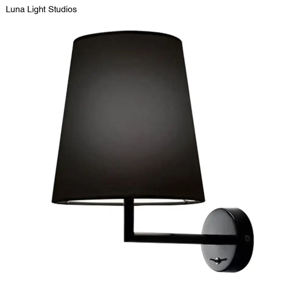 Modern white led cone wall mounted fabric sconce featuring a black drum-shaped lampshade and matte black circular base