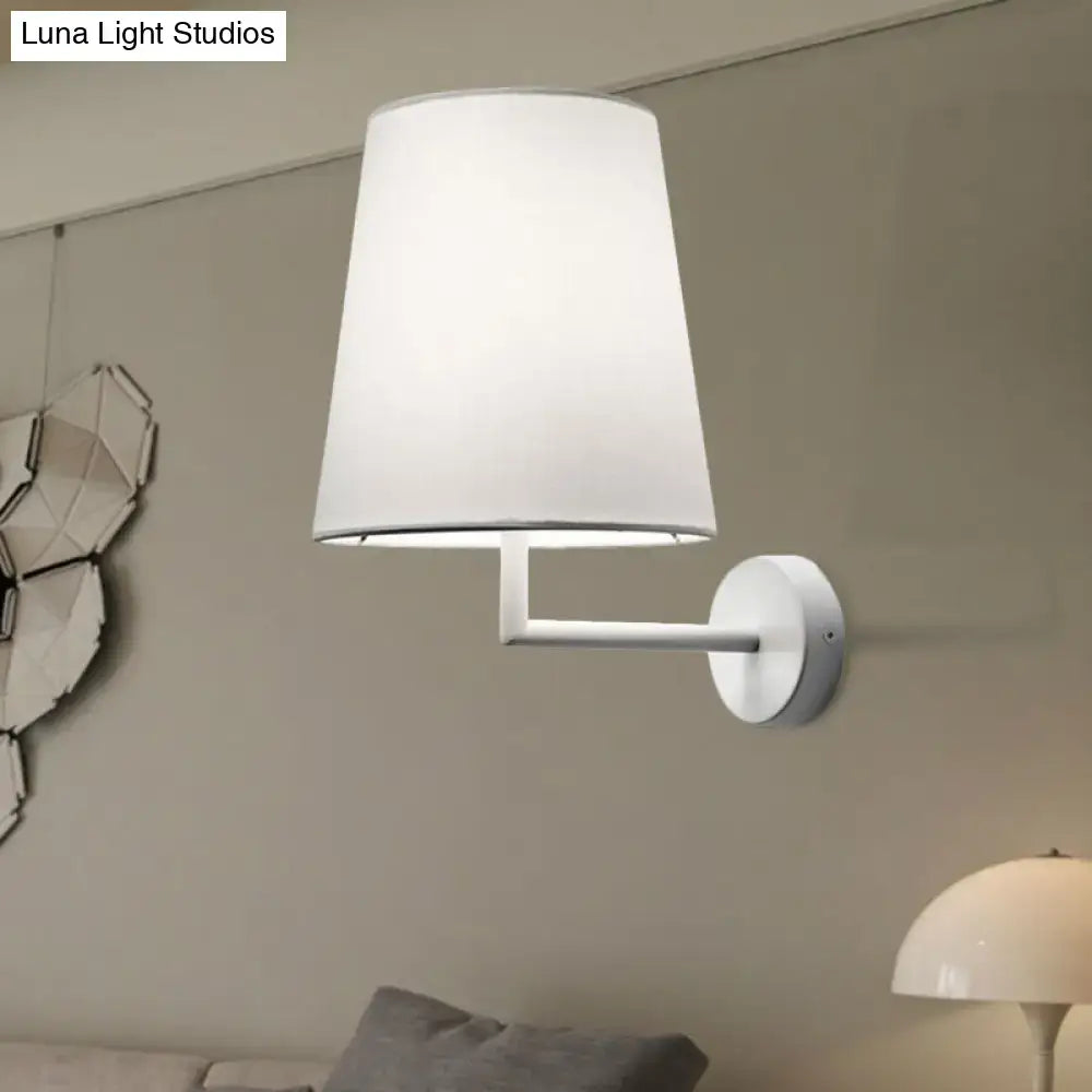 Modern white led cone wall mounted fabric sconce featuring a white cylindrical lampshade and minimalist design for living room lighting