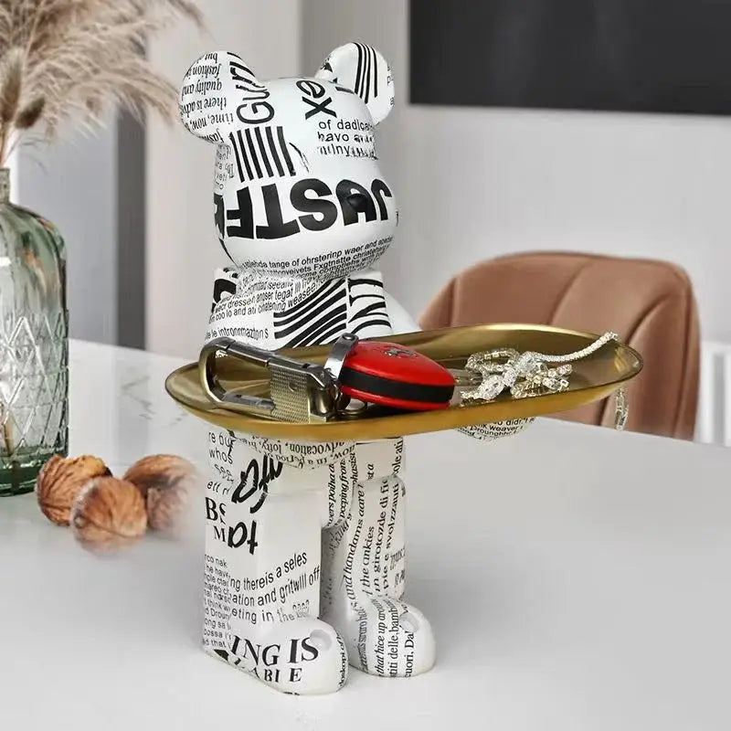Modern white marble bear figurine sculpture with black print and zebra accents standing on a gold tray for living room