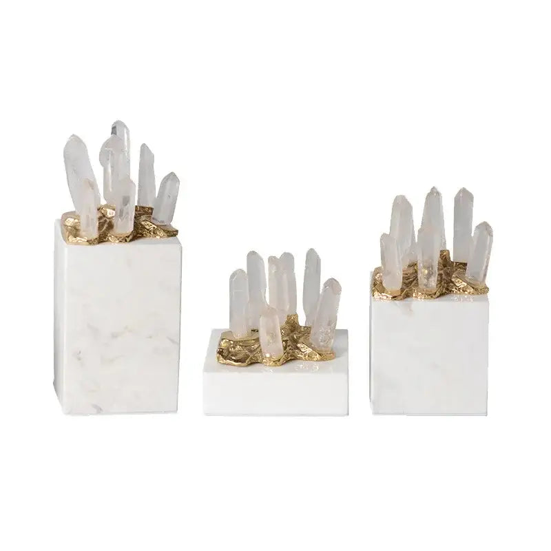Set of three modern white marble crystal stone bases with gold accents and clear quartz clusters for living room decor