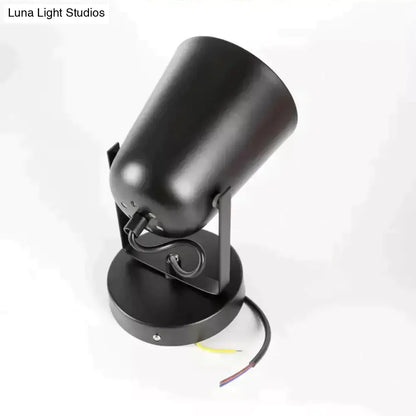 Black matte-finished adjustable spotlight with cylindrical head and circular base for modern ferrell wall lamp use