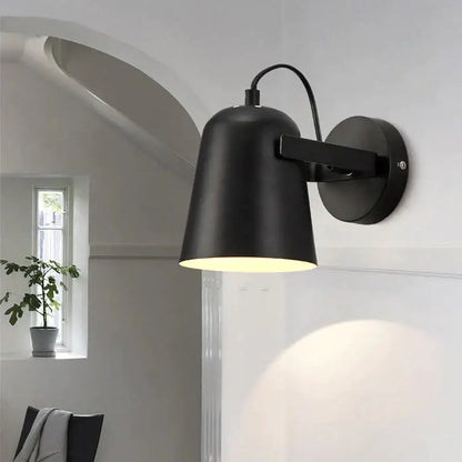 Black matte ferrell wall lamp with conical shade and adjustable arm for modern bedroom spotlight lighting