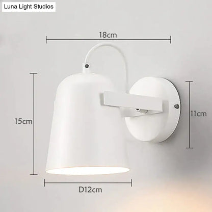 Modern white matte ferrell wall lamp with a sleek conical shade and curved arm for adjustable bedroom lighting