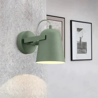 Matte sage green metal ferrell wall lamp with curved arm and conical shade for modern adjustable bedroom lighting