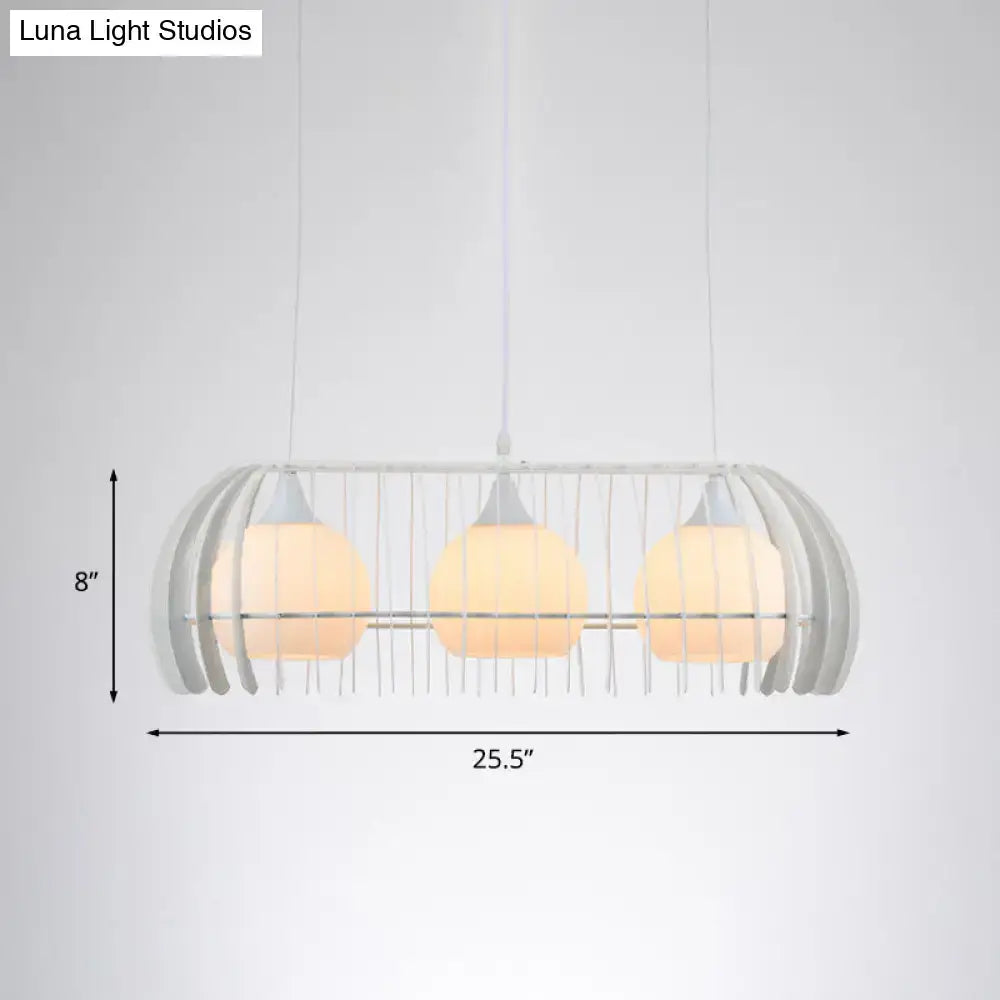 Modern white wireframe pendant lamp with three warm glass globes as a dining room island light fixture