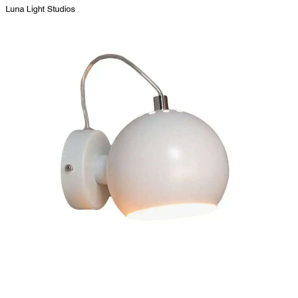 A sleek modern wall light with a frosted white metal shade and curved arm 110v-120v bedroom fixture