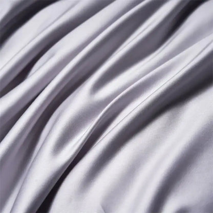 Modern white and navy egyptian cotton luxury bedding set featuring smooth silvery-gray satin fabric with subtle sheen