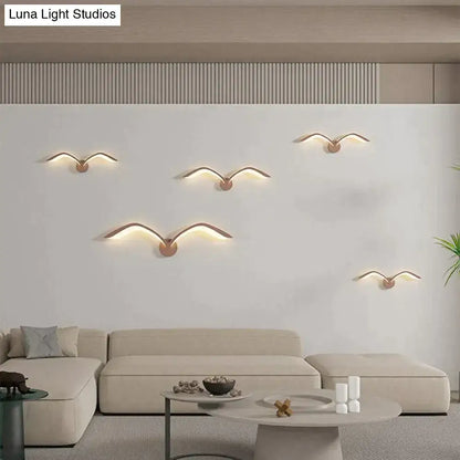Five modern copper-toned seagull wall lamp sconces with warm led lighting in nordic avian style indoor decor