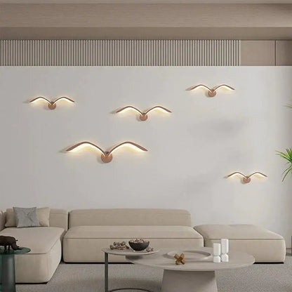 Modern white nordic avian style wall lamp featuring five warm metallic seagull sconces with glowing led wings for indoor use