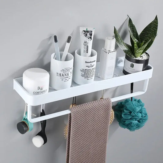 Modern white plastic corner shelf with integrated towel bar holding beige towel teal loofah and decorbites black corner brush for kitchen storage