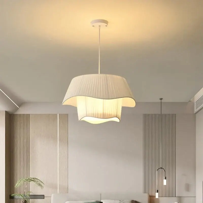 A modern pendant light with a soft cream-colored pleated fabric shade and sleek white ceiling mount for bedroom decorbites creamy style e27