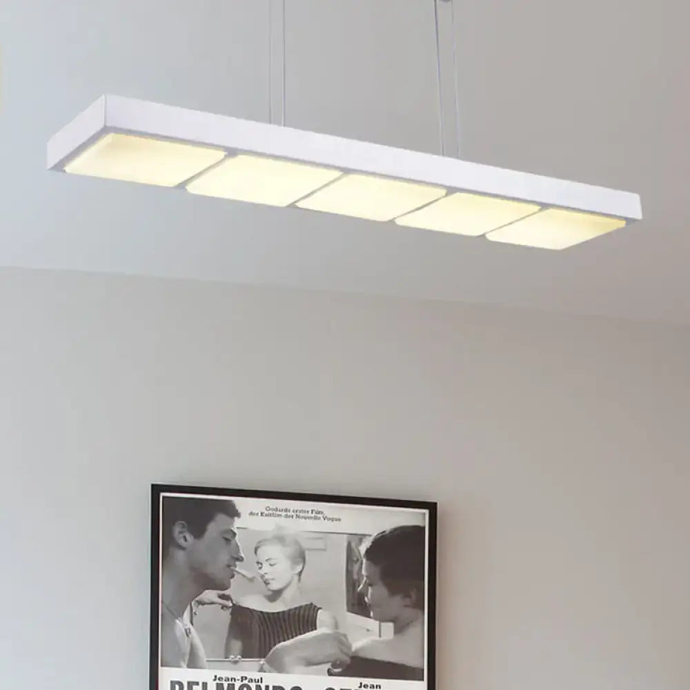 Modern white metal rectangular island lamp with five softly glowing illuminated panels for office lighting