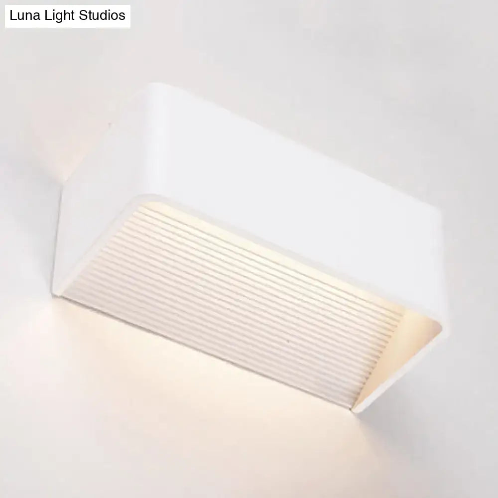 Modern white rectangular wall lamp with ribbed diffuser panel emitting warm white soft illumination for bedroom use