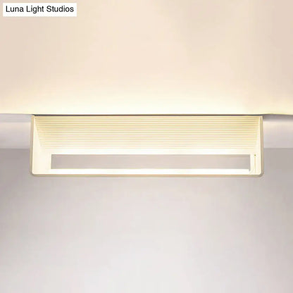 Modern off-white rectangular wall lamp with horizontal slats providing warm white light for bedroom use