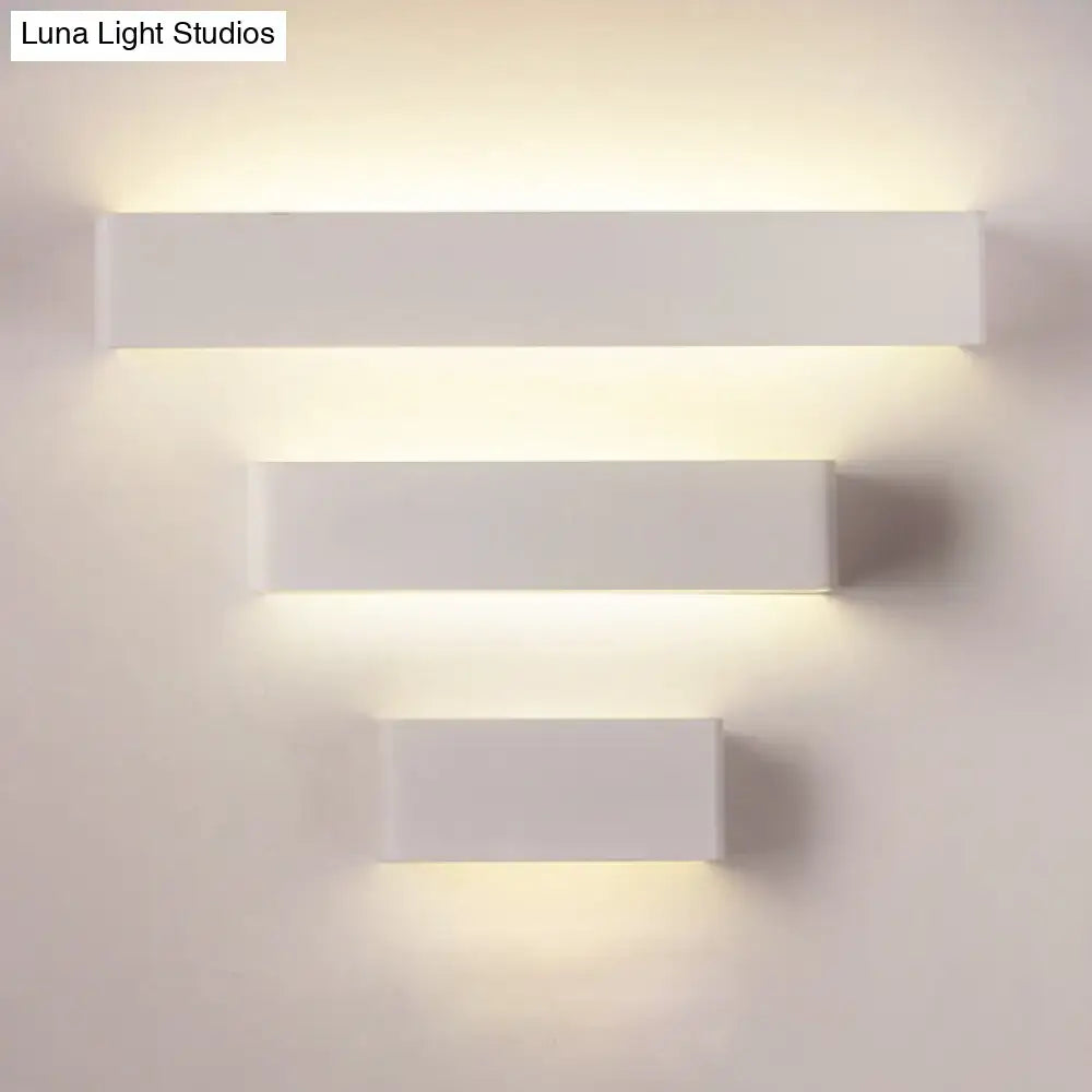 Modern white rectangular wall lamp with sleek minimalist design and warm white ambient lighting for bedrooms