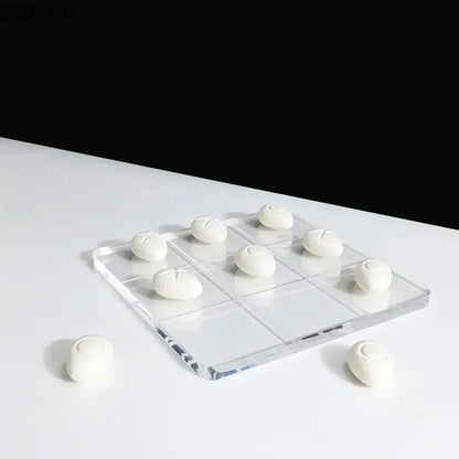 Modern clear acrylic tic-tac-toe set with white textured resin pieces for living room decor by decorbites acrylic