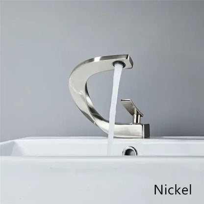 Modern basin faucet with nickel finish, sleek curved spout, and rectangular handle for elegant rose gold bathroom setup