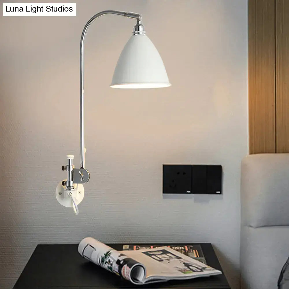 Modern white sconce wall lamp with a sleek metal shade and chrome arm mounted on an adjustable wall bracket