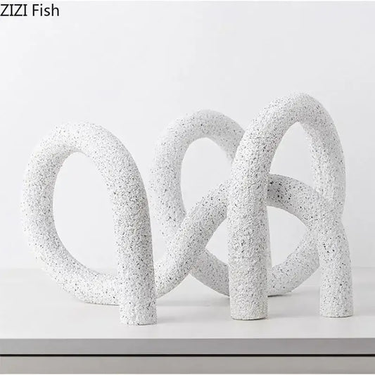 Modern white speckled resin abstract twisted knot sculpture with interlocking looped forms for living room decor