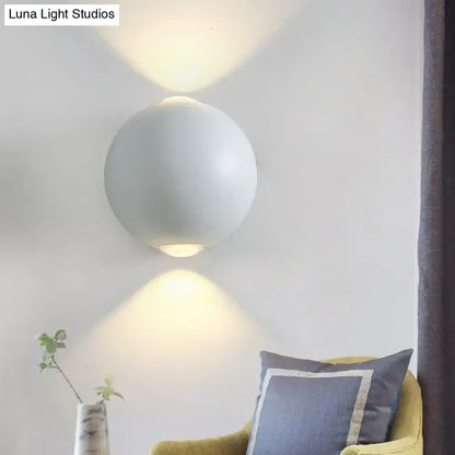 Modern white spherical wall light fixture with a sleek matte finish and minimalist design for outdoor wall light use