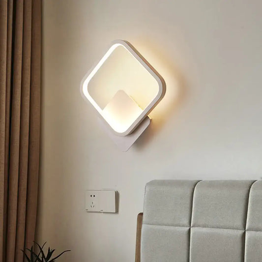 Modern white square bedside wall lamp with minimalist design and soft ambient black white lighting for bedroom use