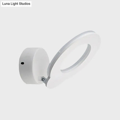 Modern white circular wall sconce with warm natural color temperature and minimalist design for bedroom lighting