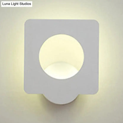 Modern white square led wall sconce with matte finish and circular cutout emitting warm natural light with color temperature