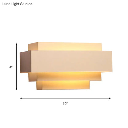 Modern beige rectangular wall sconce with layered design and warm ambient lighting ideal as a bedroom wall lamp