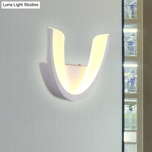 Modern white u-shaped led wall sconce with sleek curved design and warm white light for bedroom illumination