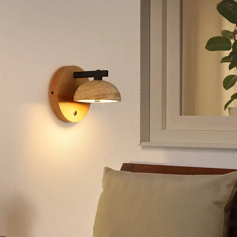 Modern wood and black iron wall light fixture with warm-toned rustic wooden base and textured stone shade for bedroom