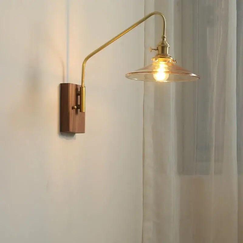 Modern wood and copper led wall sconce with brass finish, adjustable arm, and clear glass shade for bedroom or stair lighting