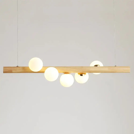DecorBites™ minimalistic milk glass suspension light with natural wood bar and five frosted globe bulbs for dining room