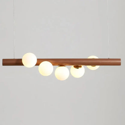 Modern copper suspension light with five frosted milk glass globes for elegant dining room lighting by DecorBites™