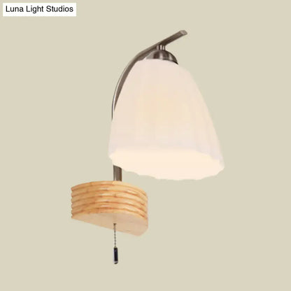 Modern wall lamp with ribbed glass flared off-white shade and woven wooden base for bedroom lighting