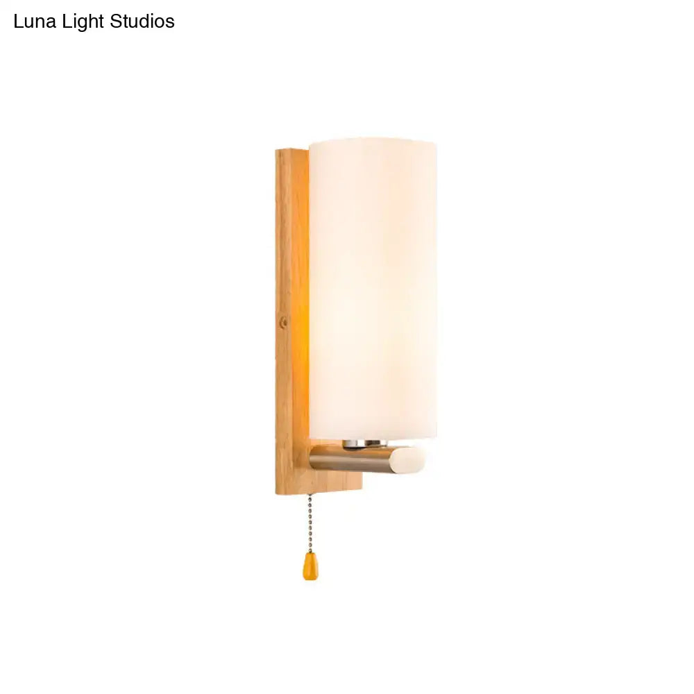 Modern wood and white glass wall sconce with warm wooden backplate frosted glass shade and pull chain light type