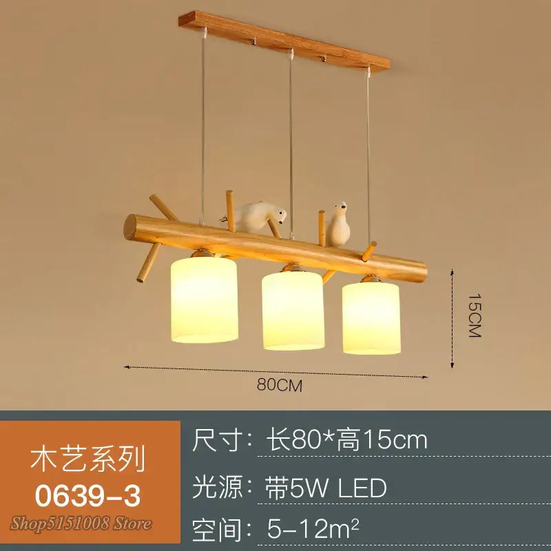 Modern wood bird glass pendant light featuring warm yellow glass shades and white bird figurines on natural wood branch