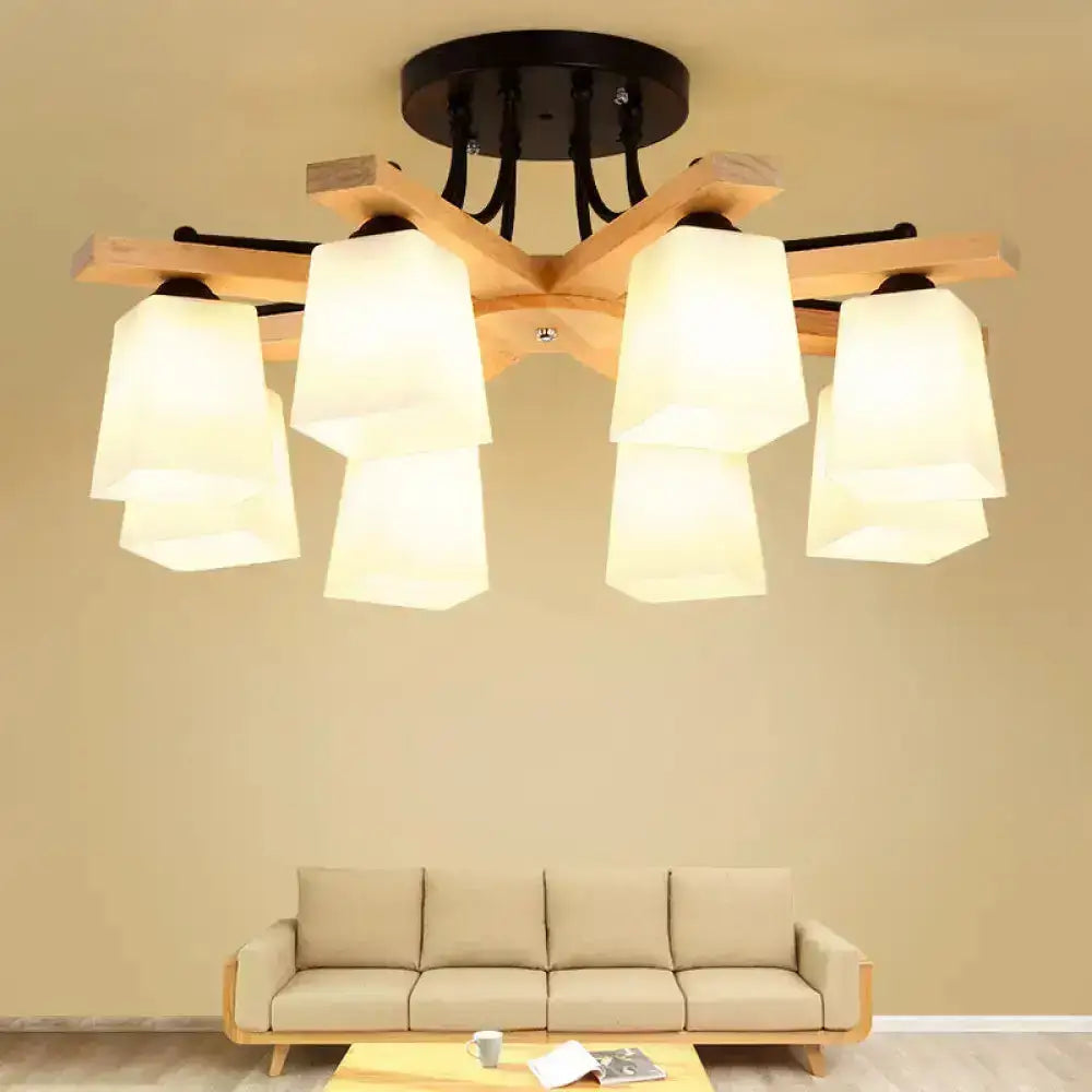 A modern wood and black semi flush mount living room light with six milk glass shade lampshades and a central mounting plate