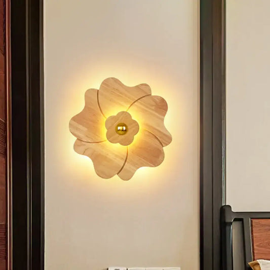 Modern wood flower wall light sconce in warm tones with a central brass accent for bedroom lighting