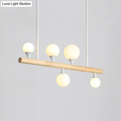 Modern wood island lamp with natural wood bar and five frosted glass globe bulbs for dining room bulb base lighting