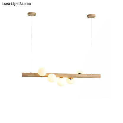 Modern minimalist ceiling light DecorBites wood island fixture with natural wood bar and frosted opal glass globes