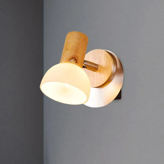 Modern wood sconce with warm-toned wooden base and milk white glass shade for bedroom wall lamp lighting